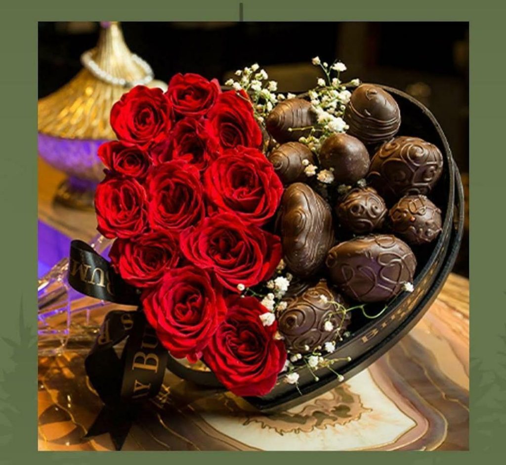 Homemade dark chocolate with butter bars on a wooden board